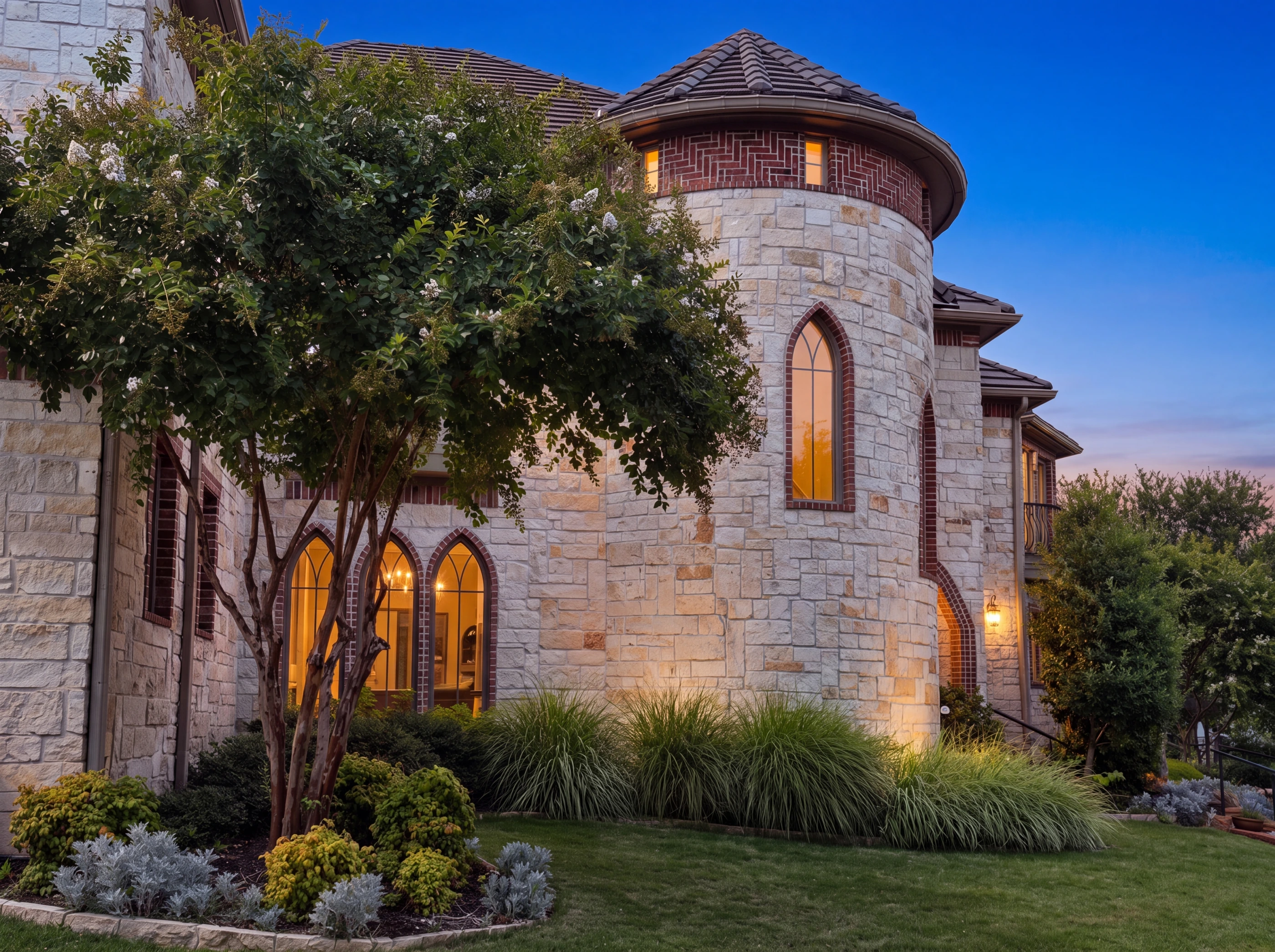 Limestone turret and arched windows at dusk